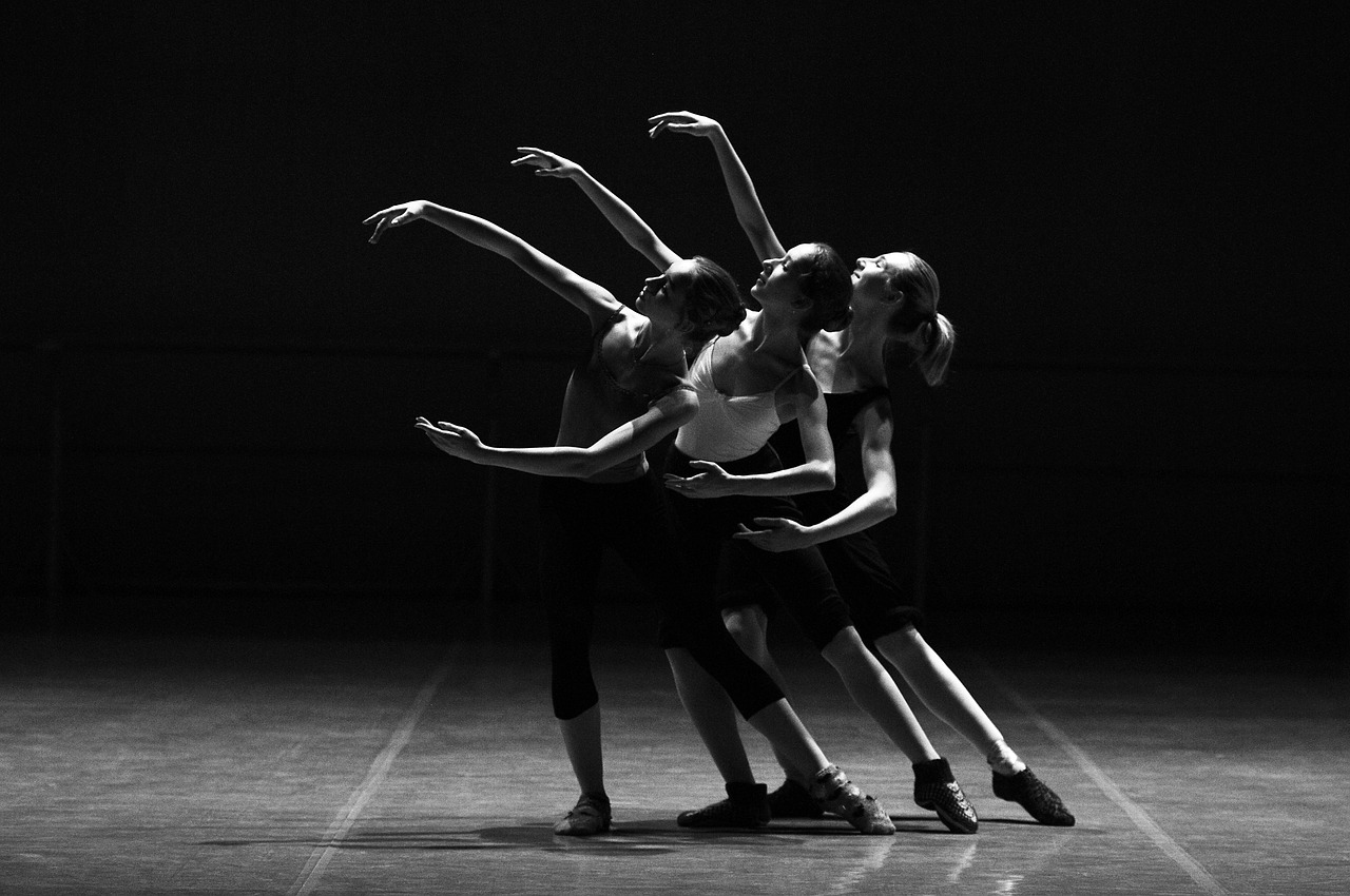 Ballet dancers performing on stage in dramatic lighting — Brevard Ballet Youth Company